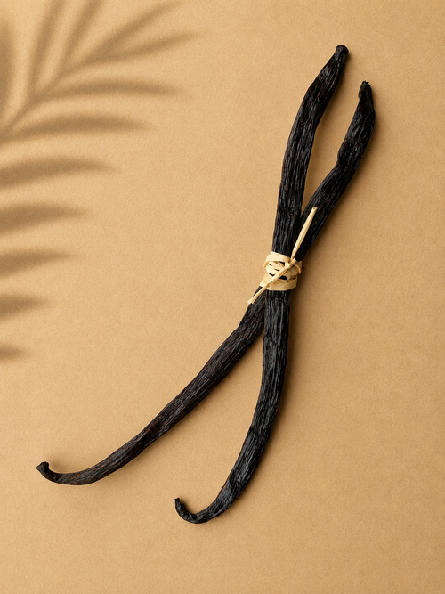 2 whole gourmet bourbon Luna vanilla beans tied with twine on a beige background