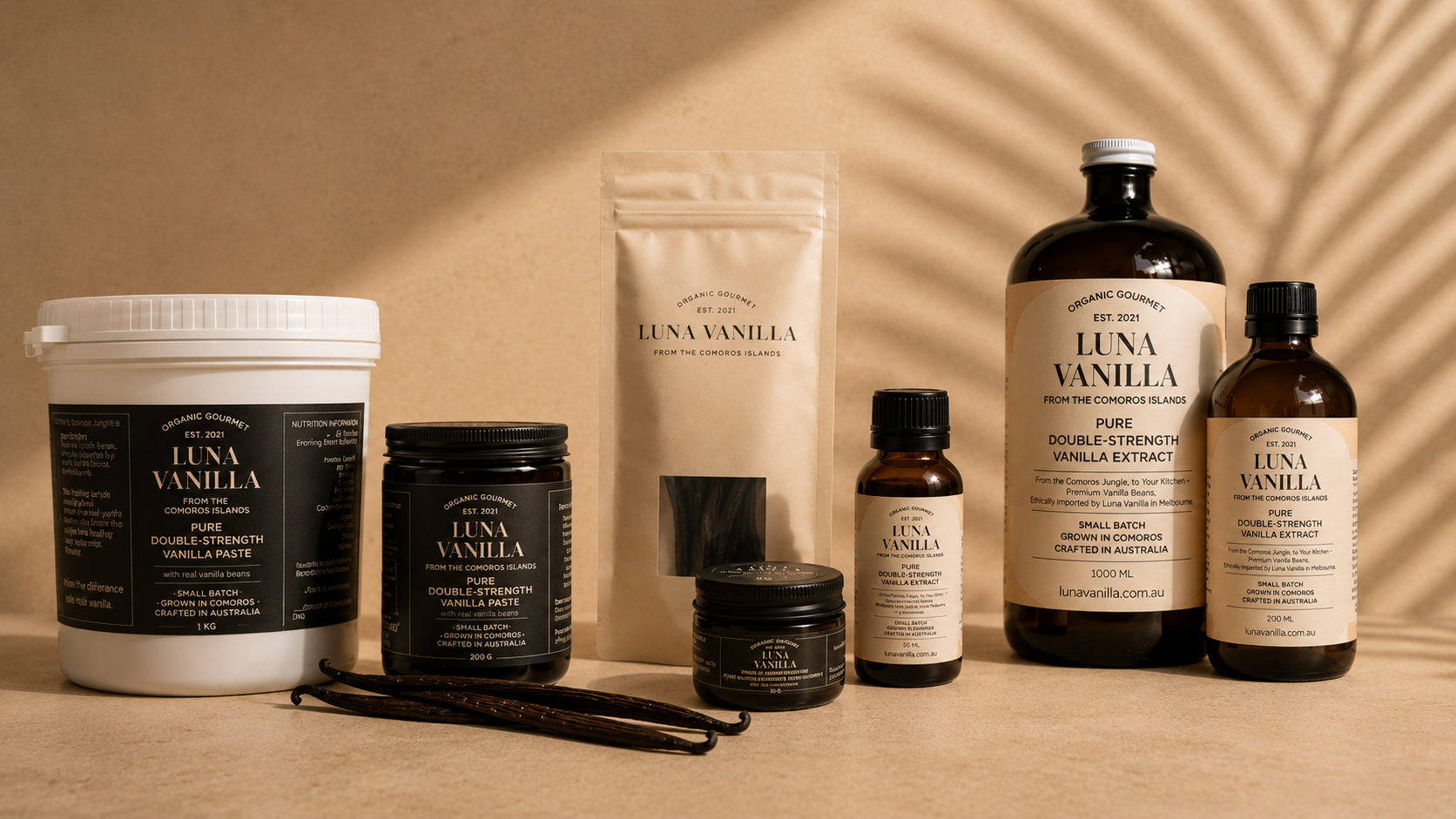 Collection of Luna Vanilla products including Vanilla paste, Vanilla extract and whole bean in a pouch on a beige background
