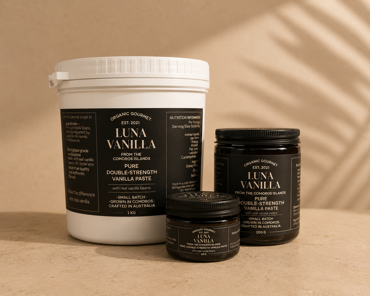 Luna Vanilla paste products including a 1 kilo white container and two smaller black containers of 250g and 50g vanilla paste on a beige background.