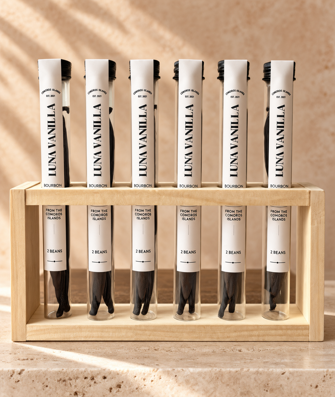 Luna Vanilla retail display stand with six tubes of Comoros Bourbon vanilla beans