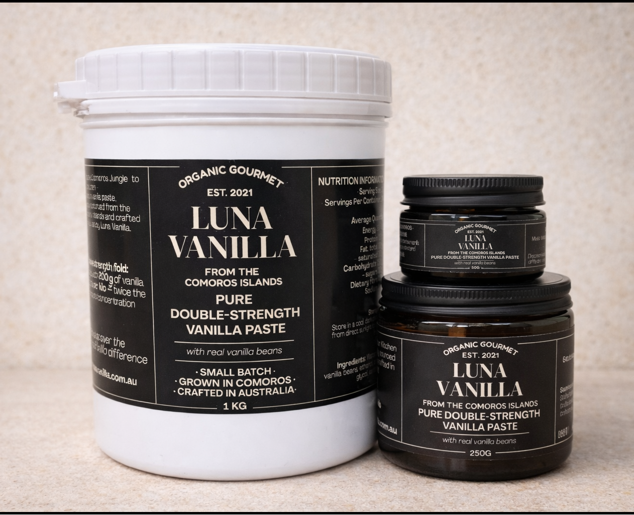 Luna Vanilla double-strength vanilla paste in 1kg, 250g and 50g sizes on warm beige travertine background